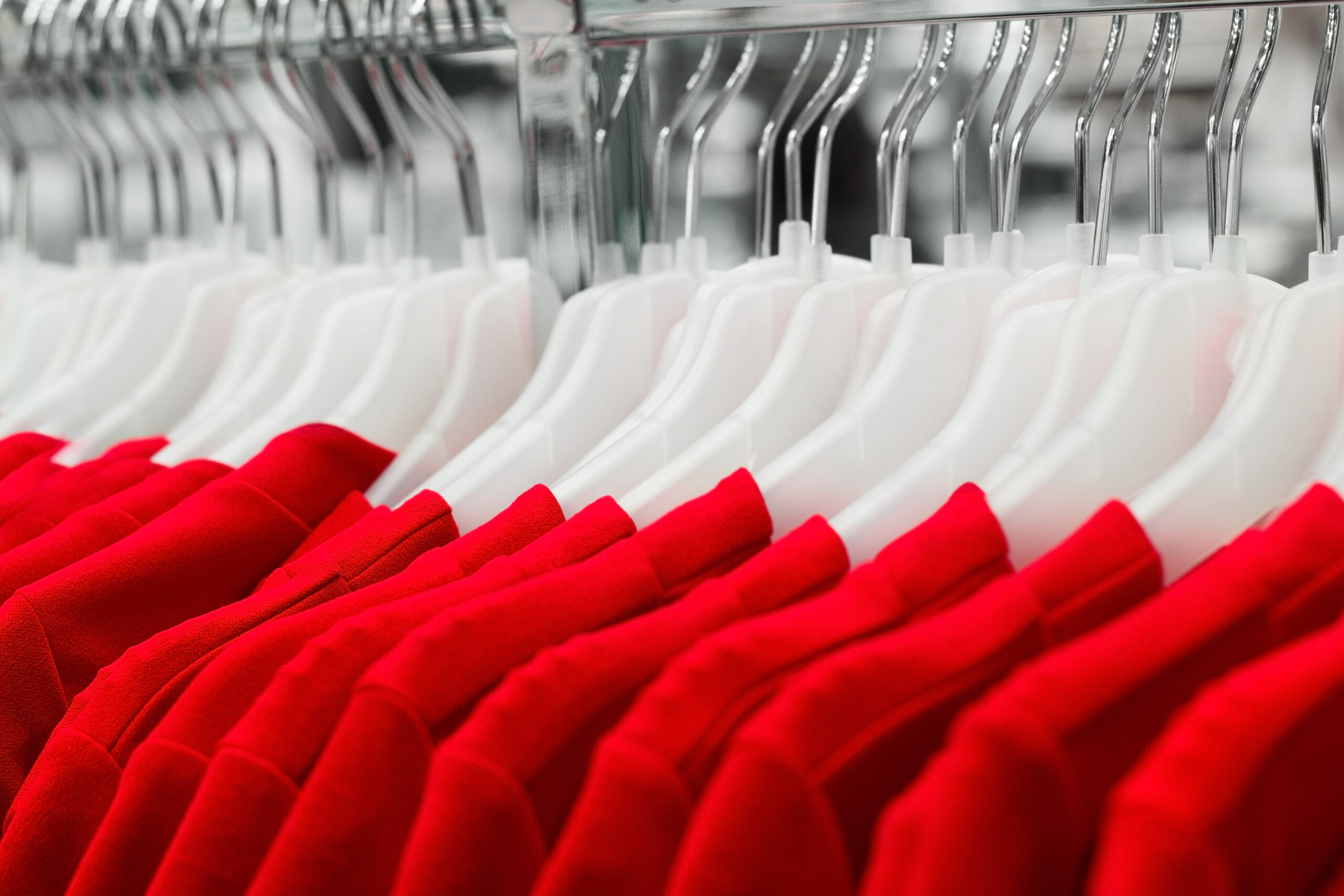 close up red dresses on hangers