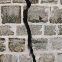 a deep crack in a brick wall