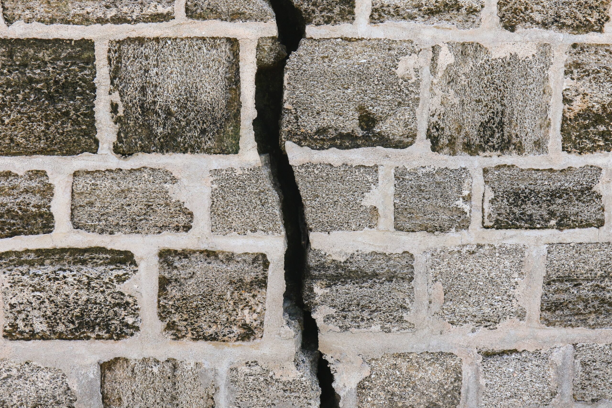 a deep crack in a brick wall